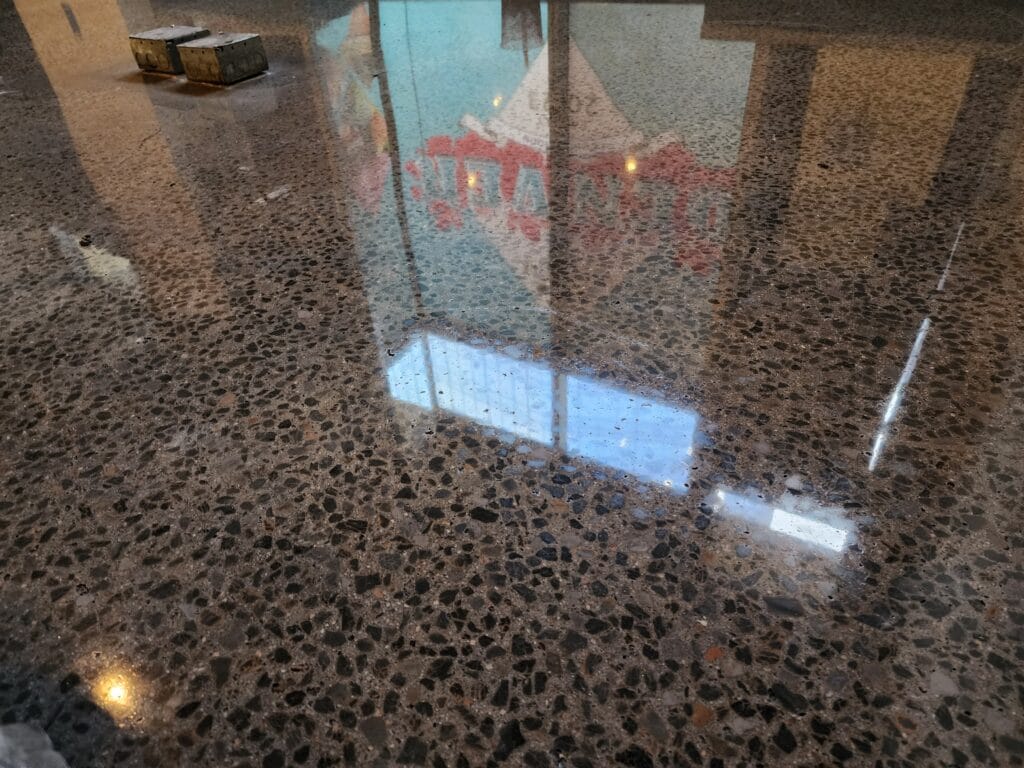 Concrete grinding Denver result showing a polished slab with exposed aggregate and a reflective finish